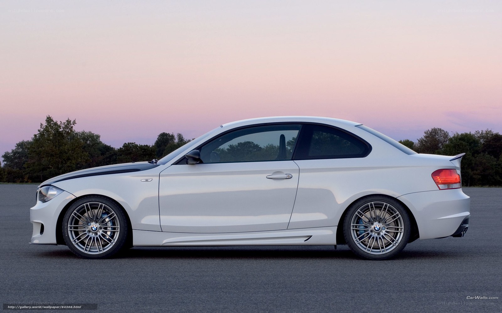 white bmw coupe at dusk