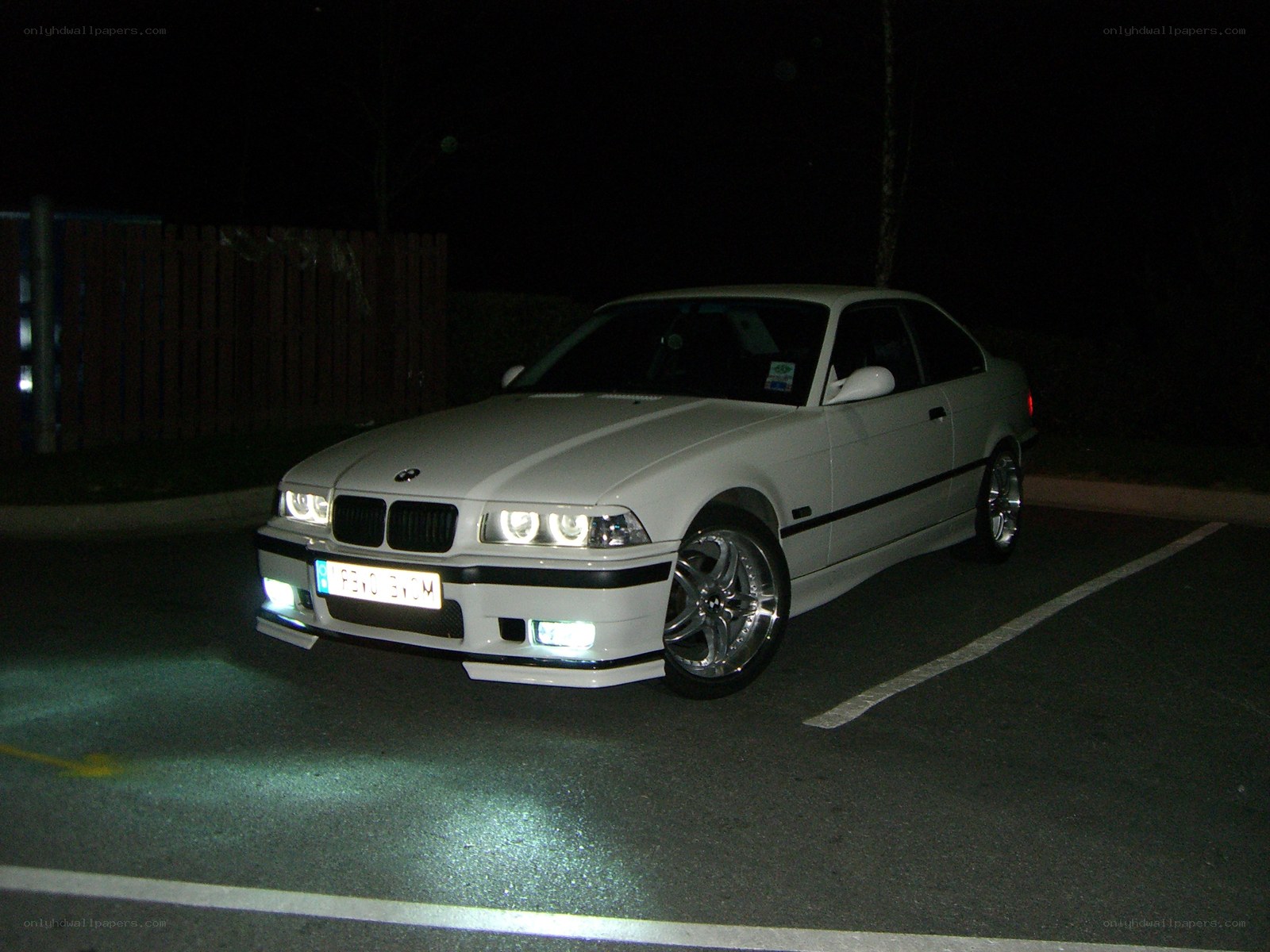 White BMW coupe at night