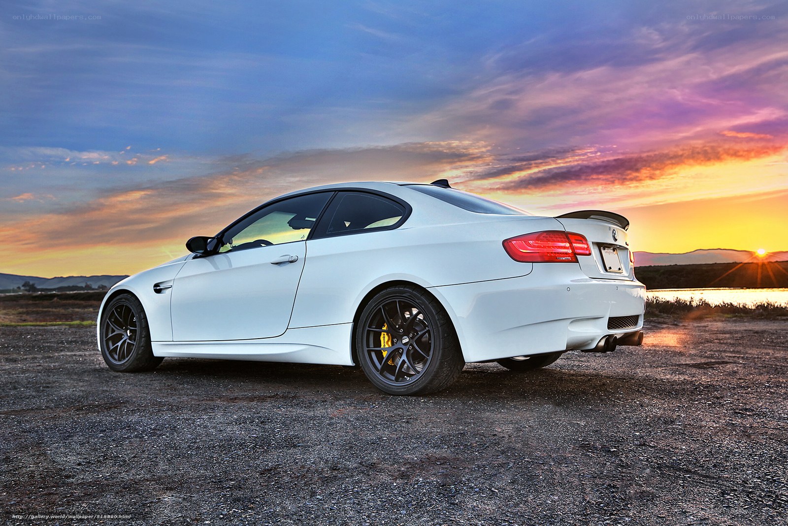 white bmw coupe at sunset