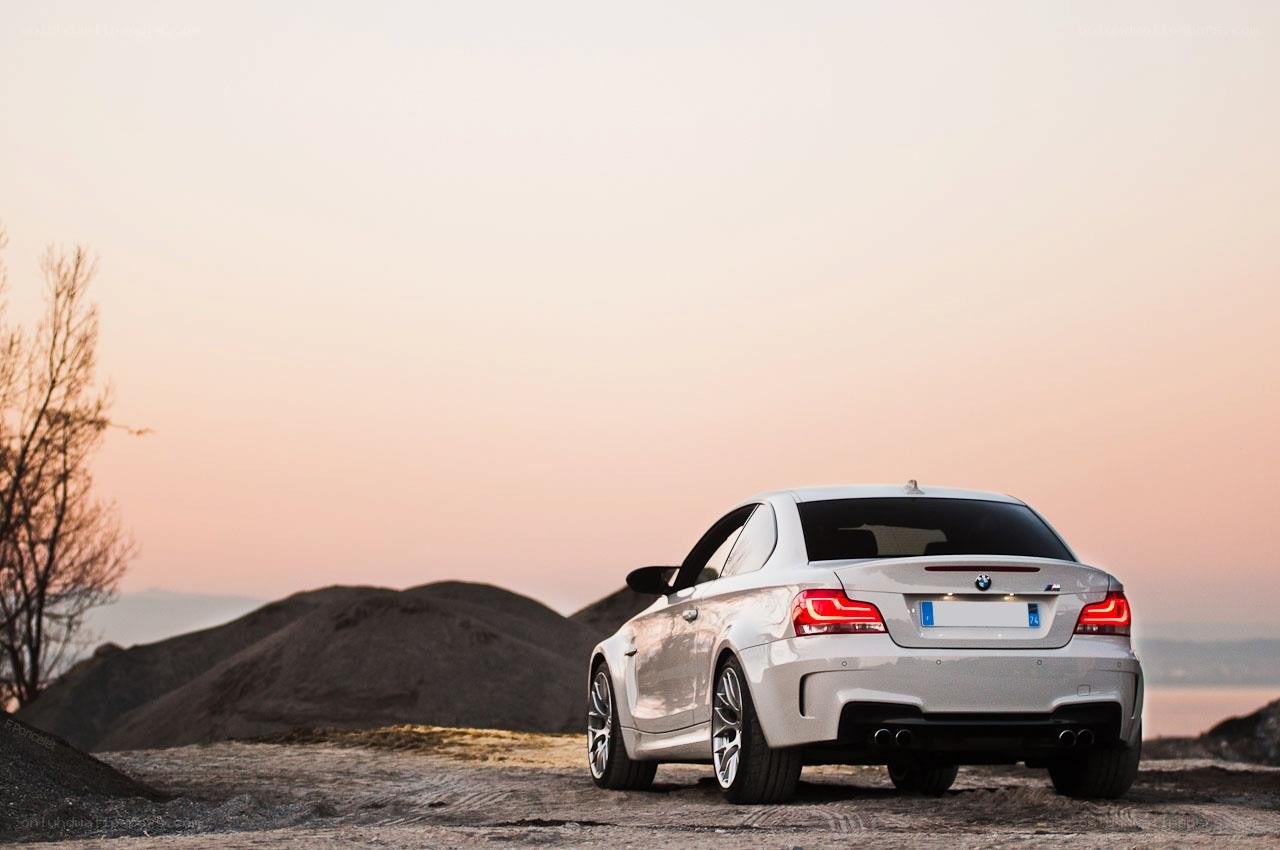 White BMW coupe at sunset