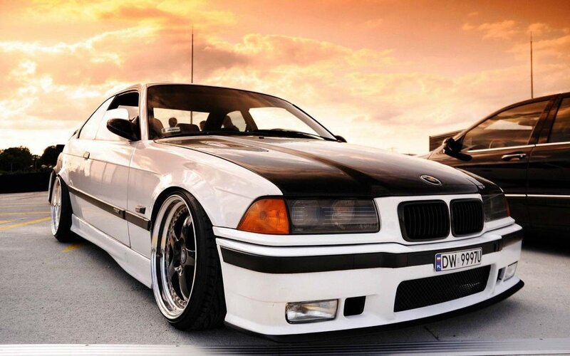 white bmw coupe at sunset
