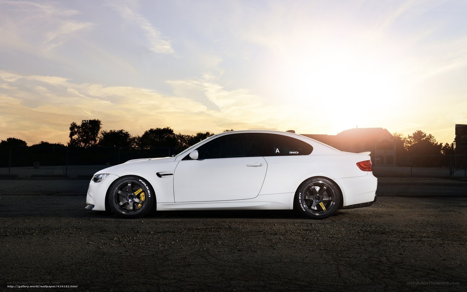white bmw coupe at sunset