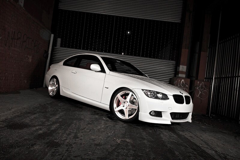 white bmw coupe in alley
