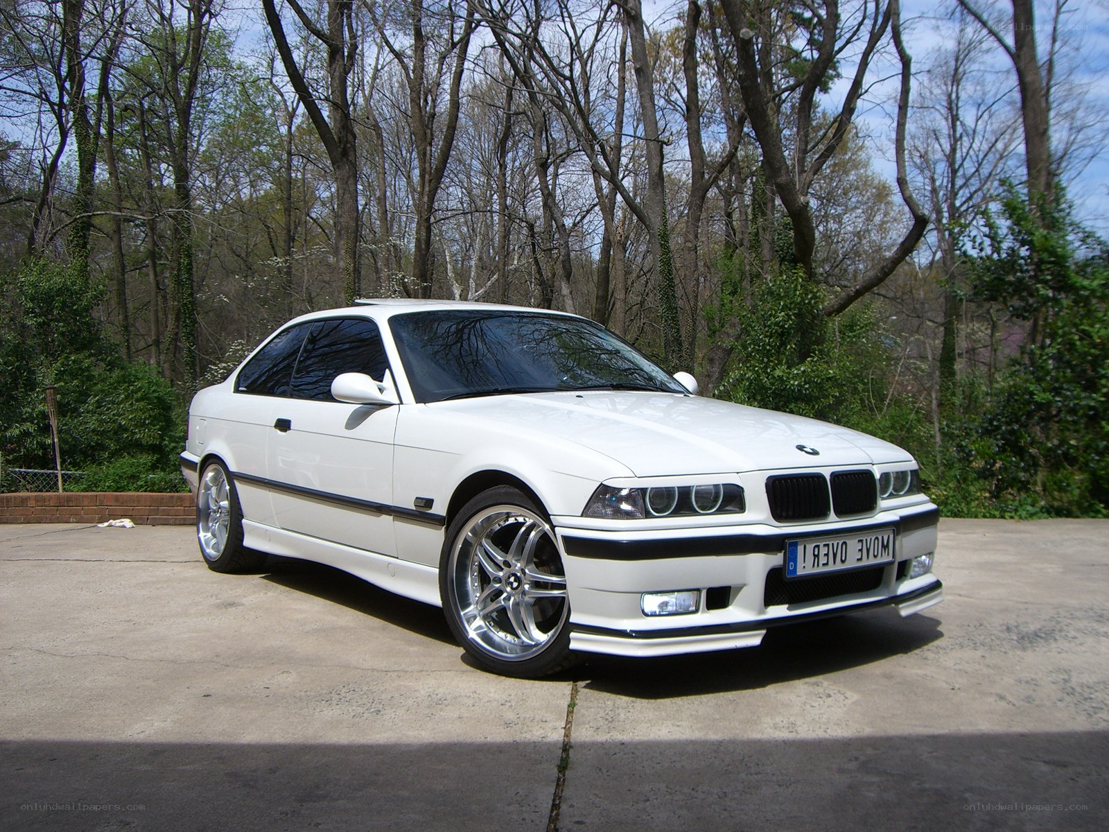 white bmw coupe in driveway