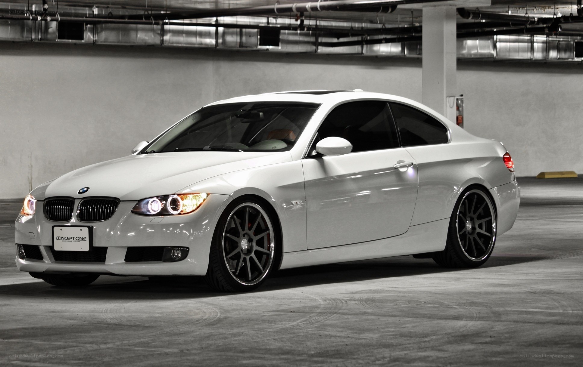 white bmw coupe in garage