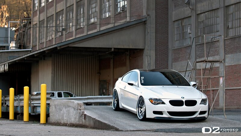 white bmw coupe in industrial area