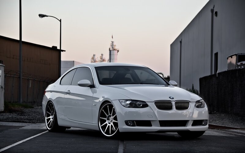 white bmw coupe in industrial area