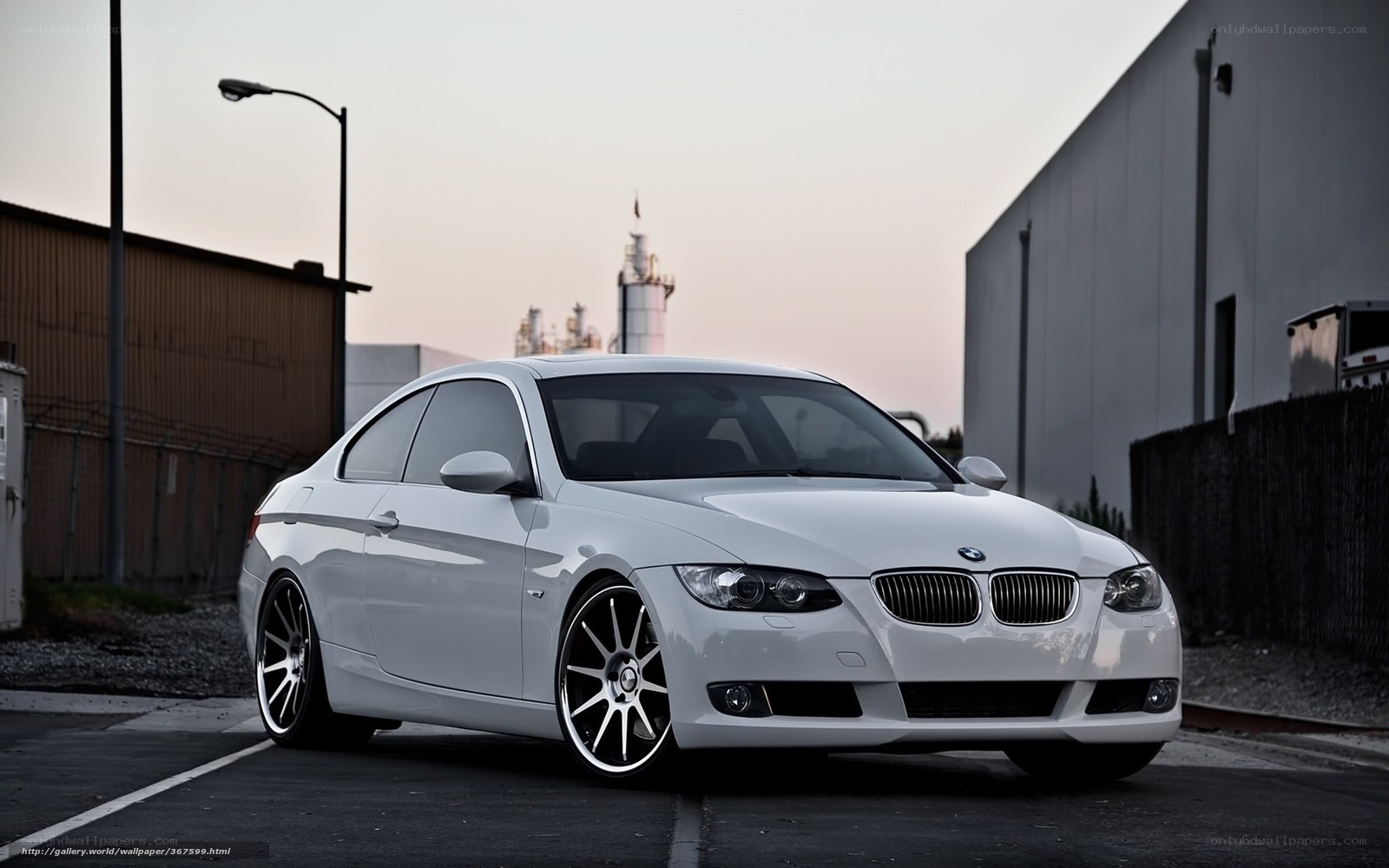 white bmw coupe in industrial area