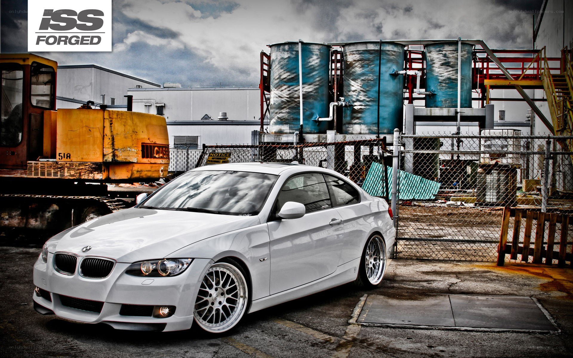 White BMW coupe in industrial setting
