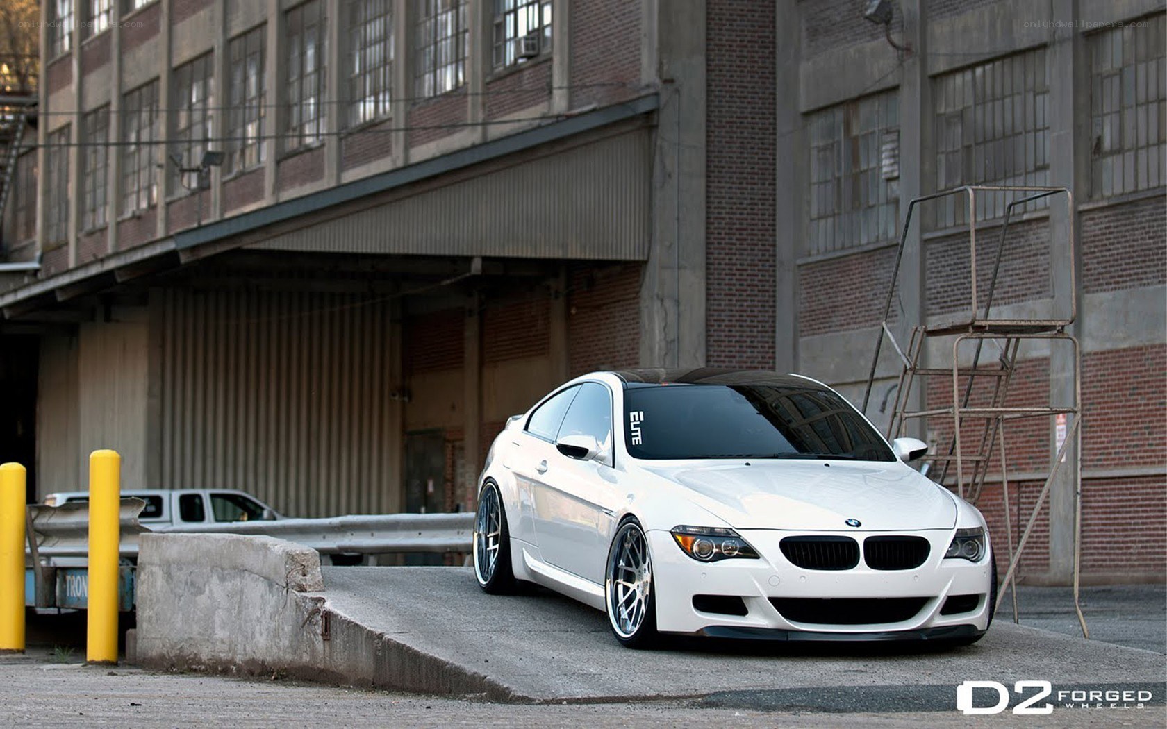 white bmw coupe in industrial setting