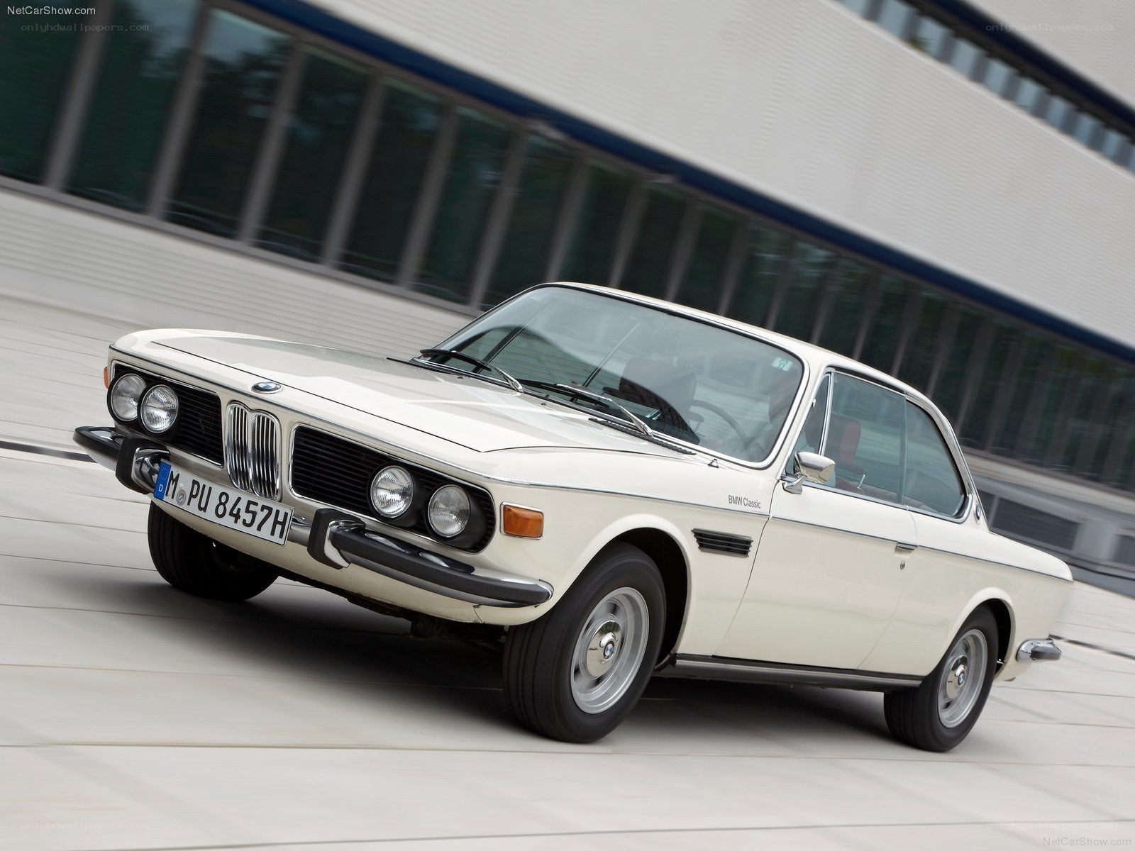 White BMW coupe in motion