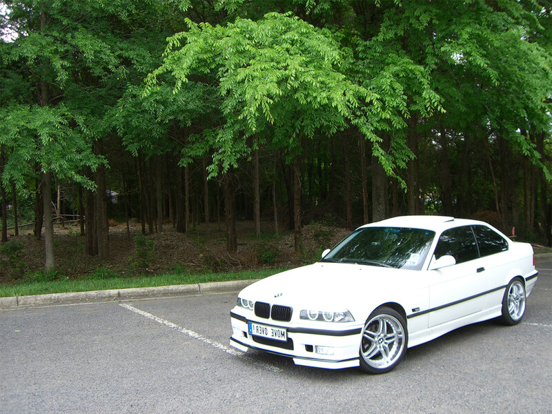 White BMW coupe in parking lot