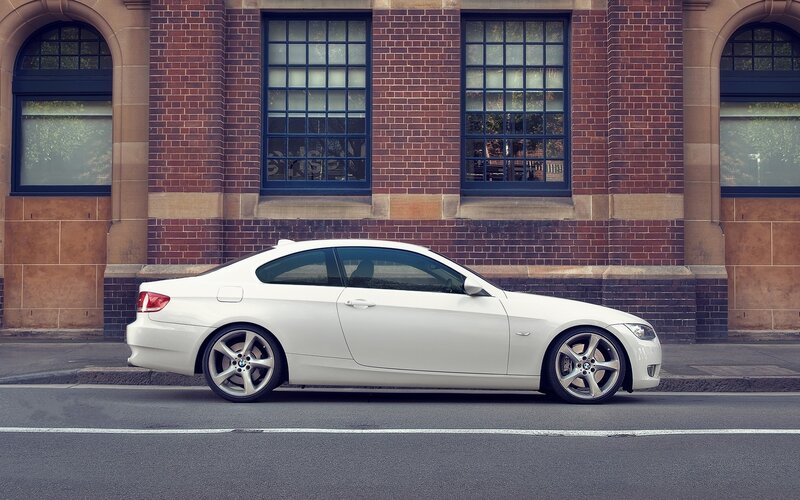 White BMW coupe on city street