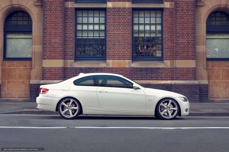 White BMW coupe on city street