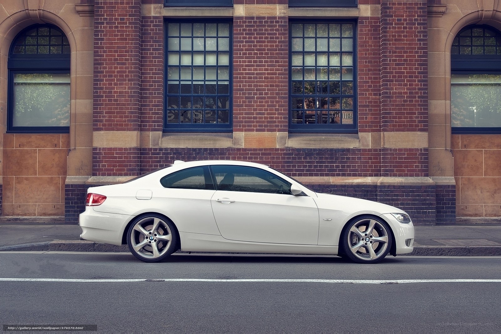 White BMW coupe on city street
