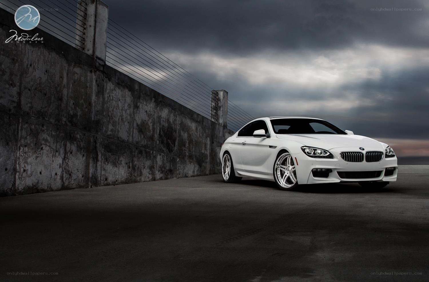 White BMW coupe on concrete