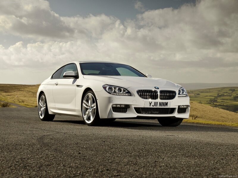 white bmw coupe on country road