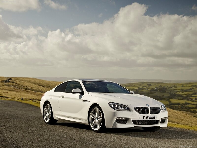 white bmw coupe on country road