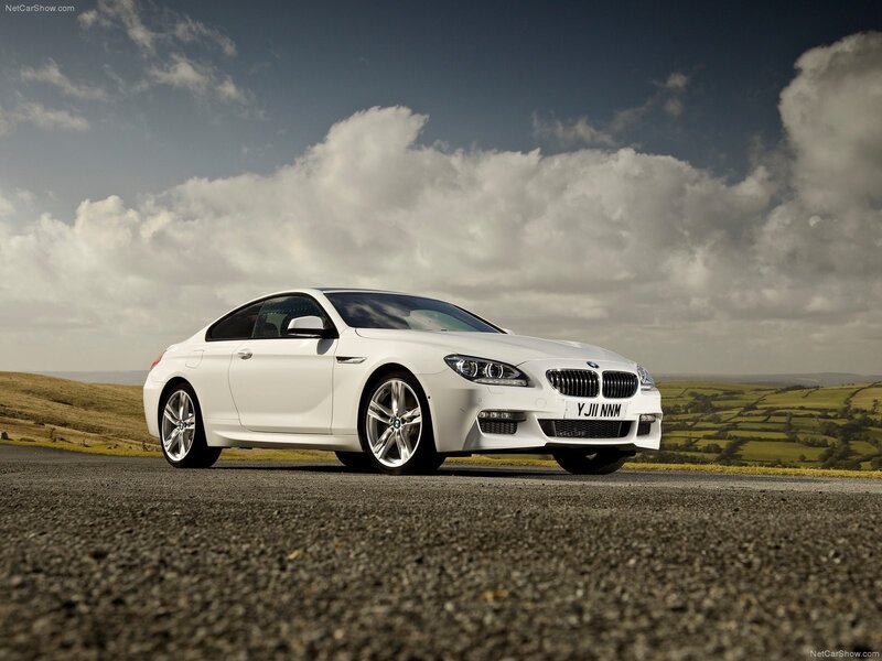 white bmw coupe on country road