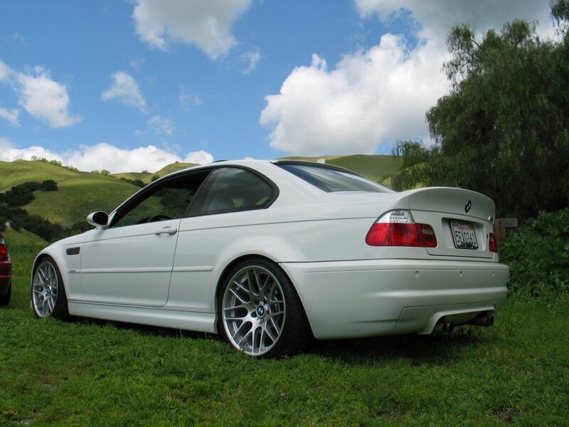 white bmw coupe on grass