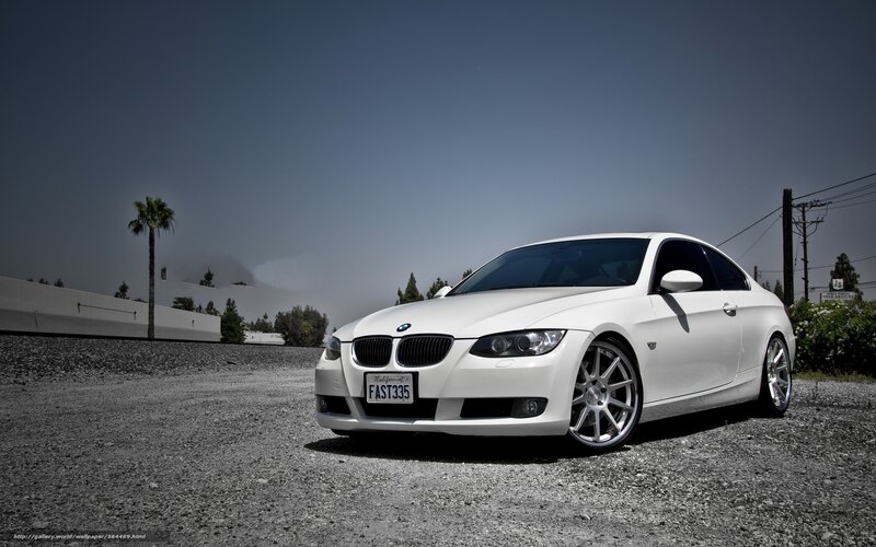 white bmw coupe on gravel