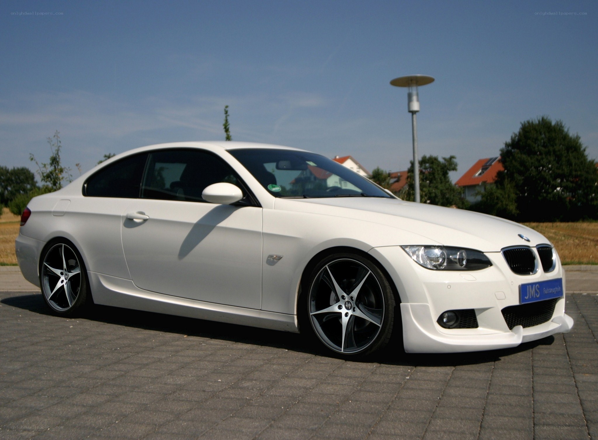 white bmw coupe on pavement