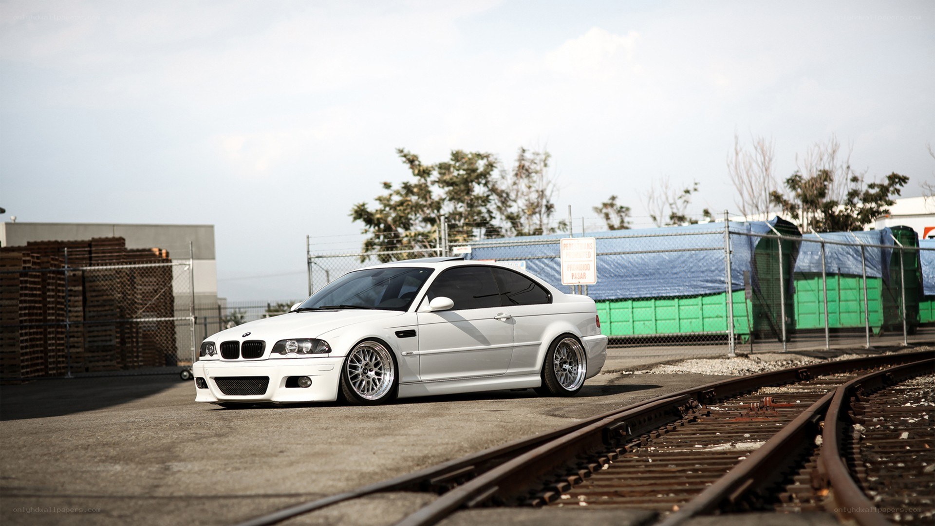 white bmw coupe on train tracks