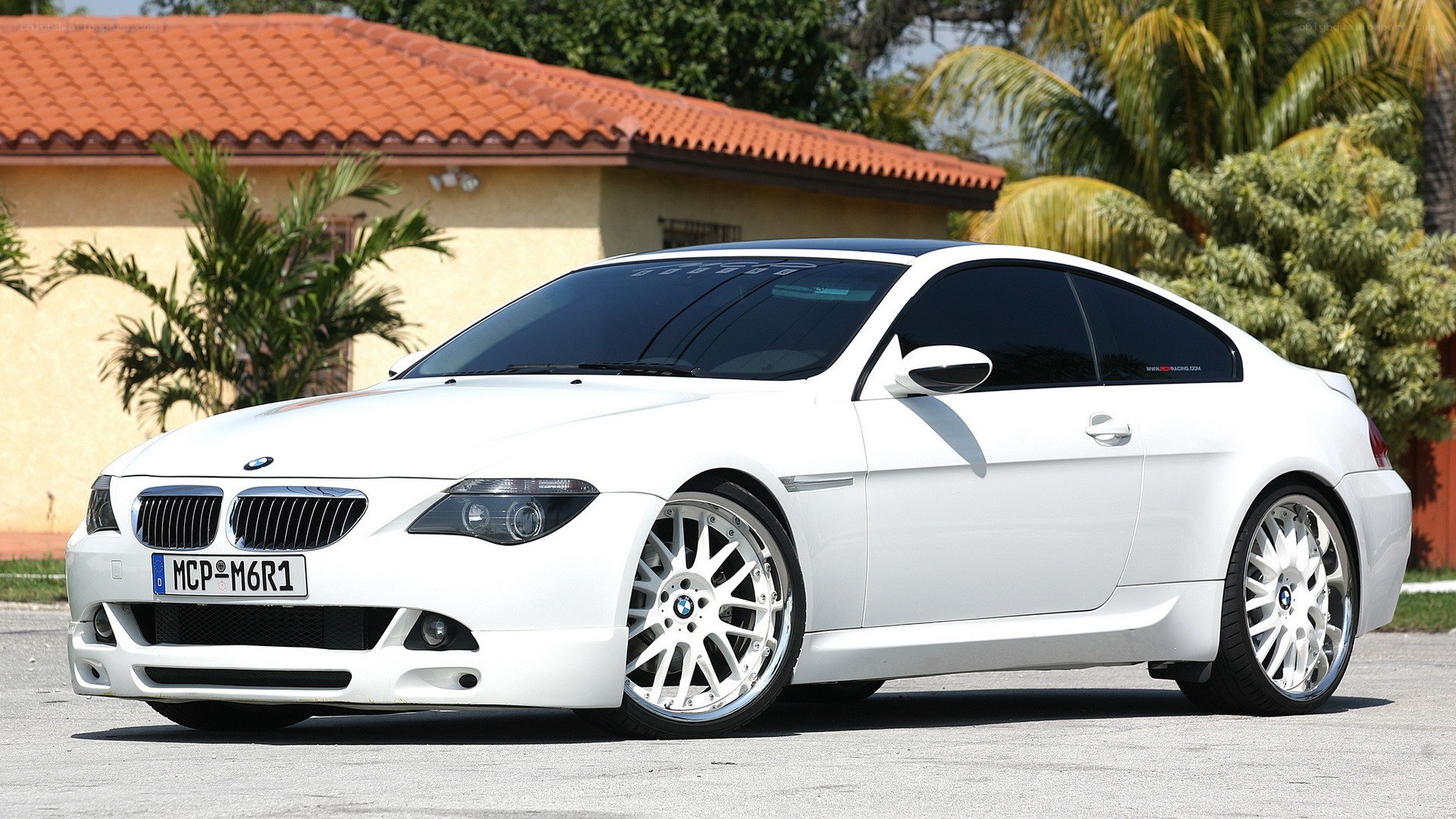 white bmw coupe parked outside