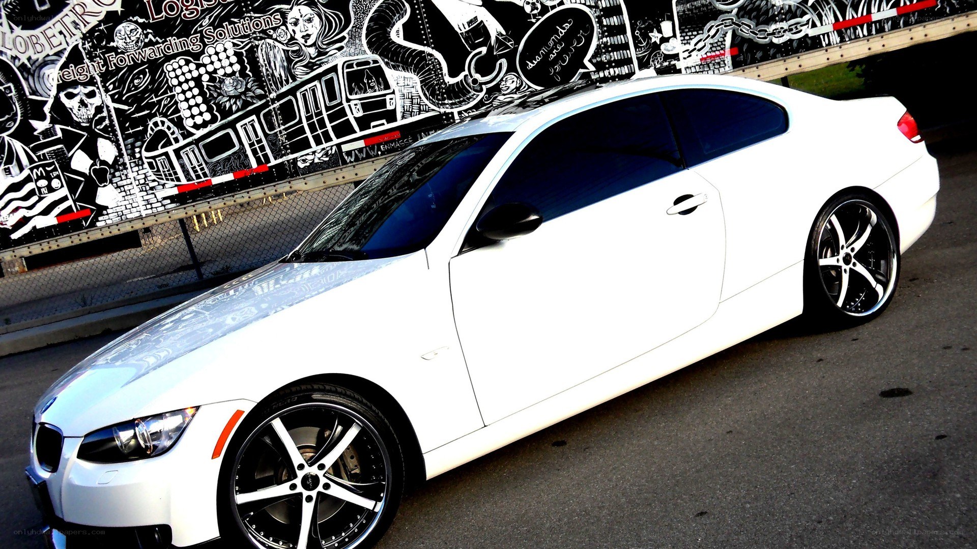 White BMW coupe with custom wheels