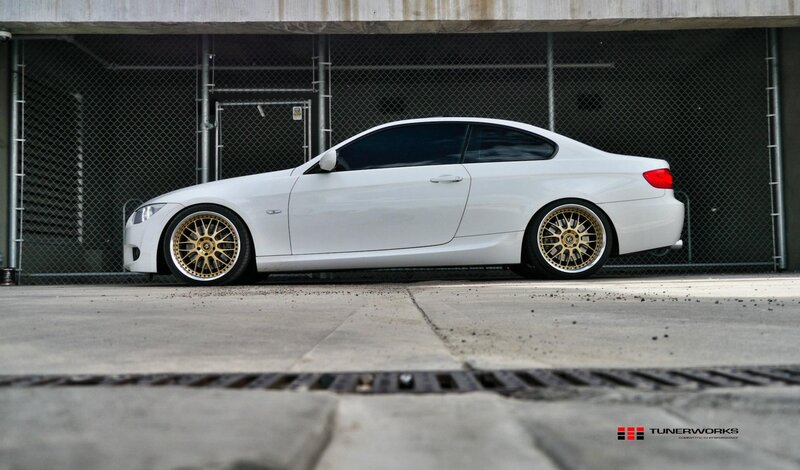 white bmw coupe with gold wheels