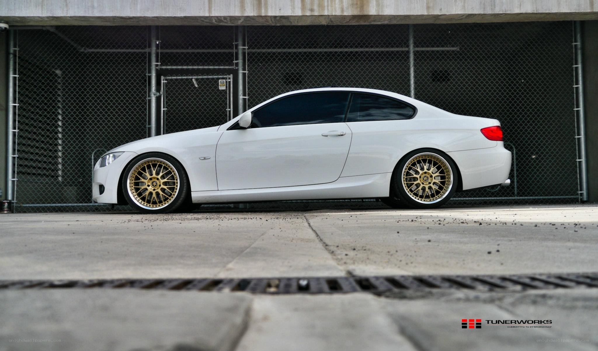 white bmw coupe with gold wheels
