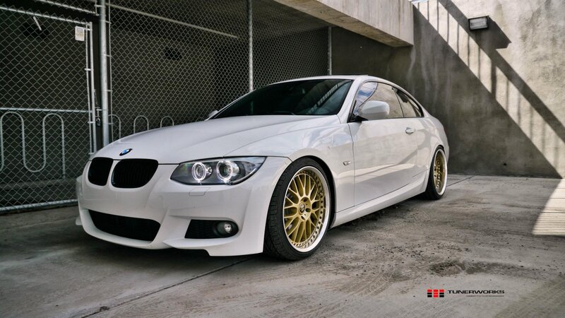 white bmw coupe with gold wheels