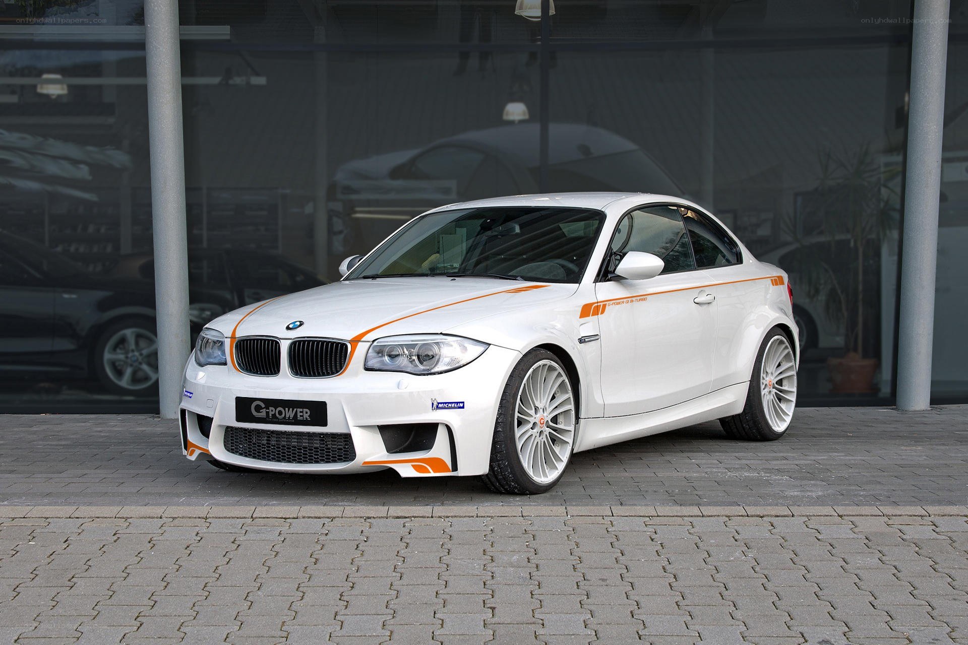 White BMW coupe with orange accents