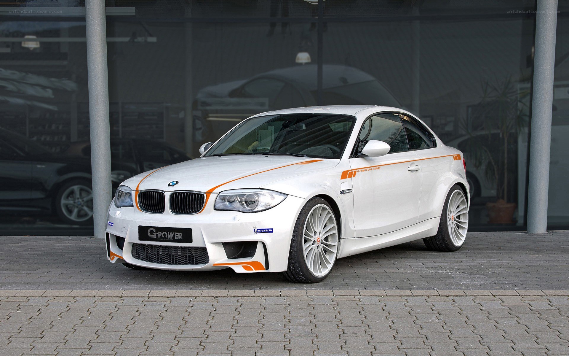 white bmw coupe with orange stripes