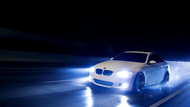 white bmw driving at night