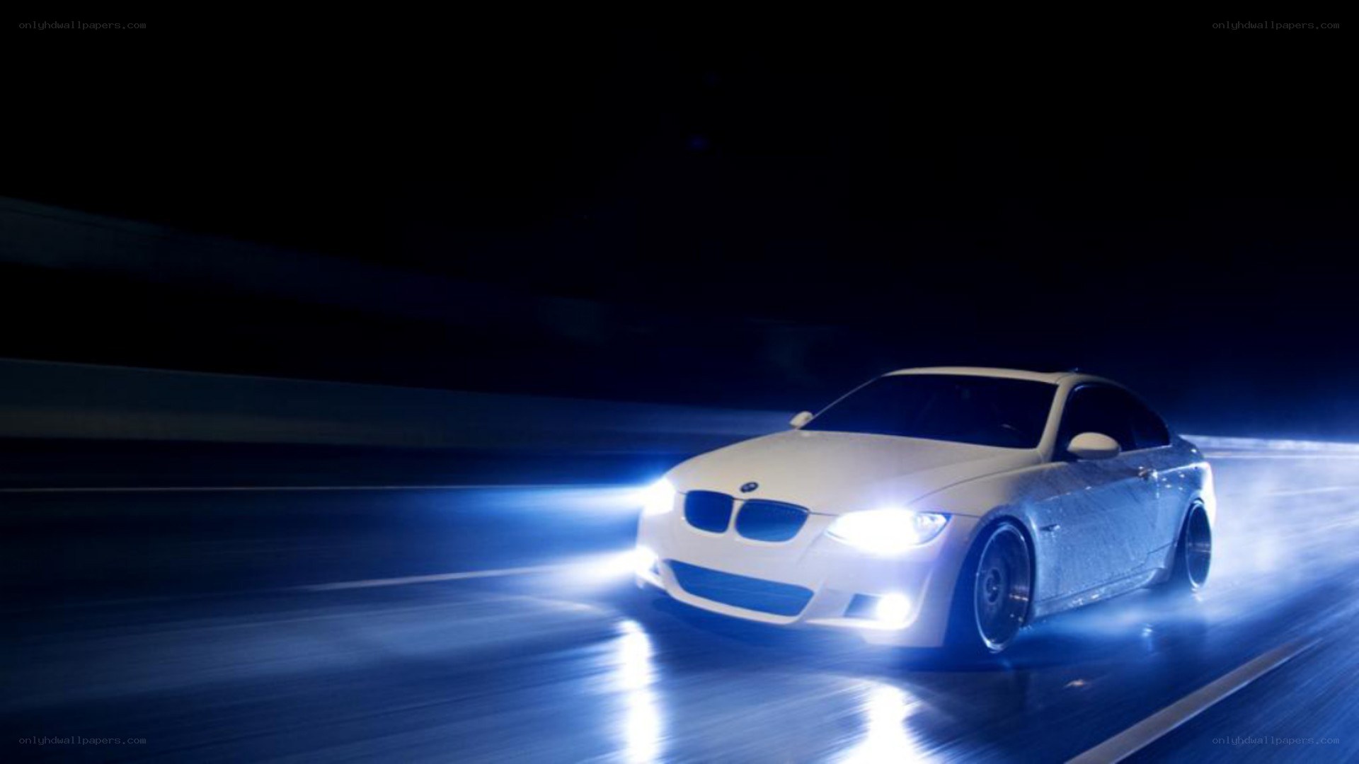 white bmw driving at night