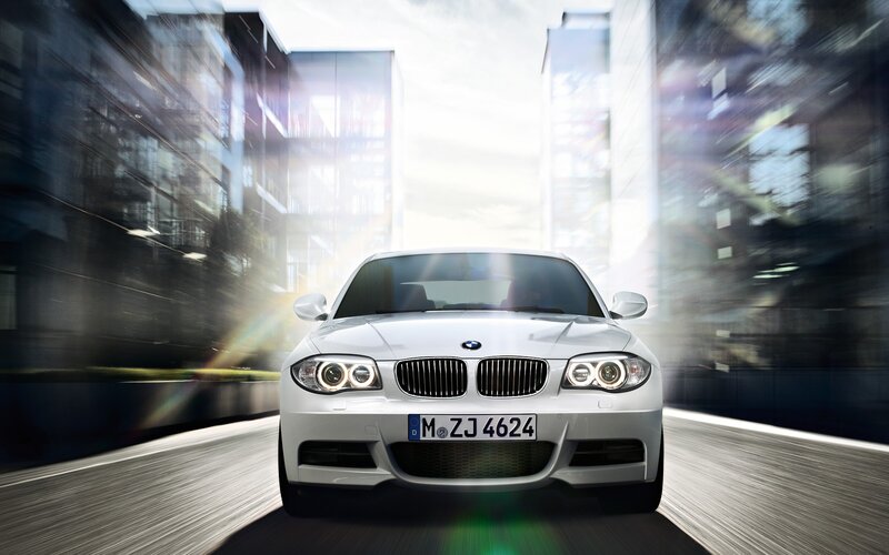 White BMW driving in city