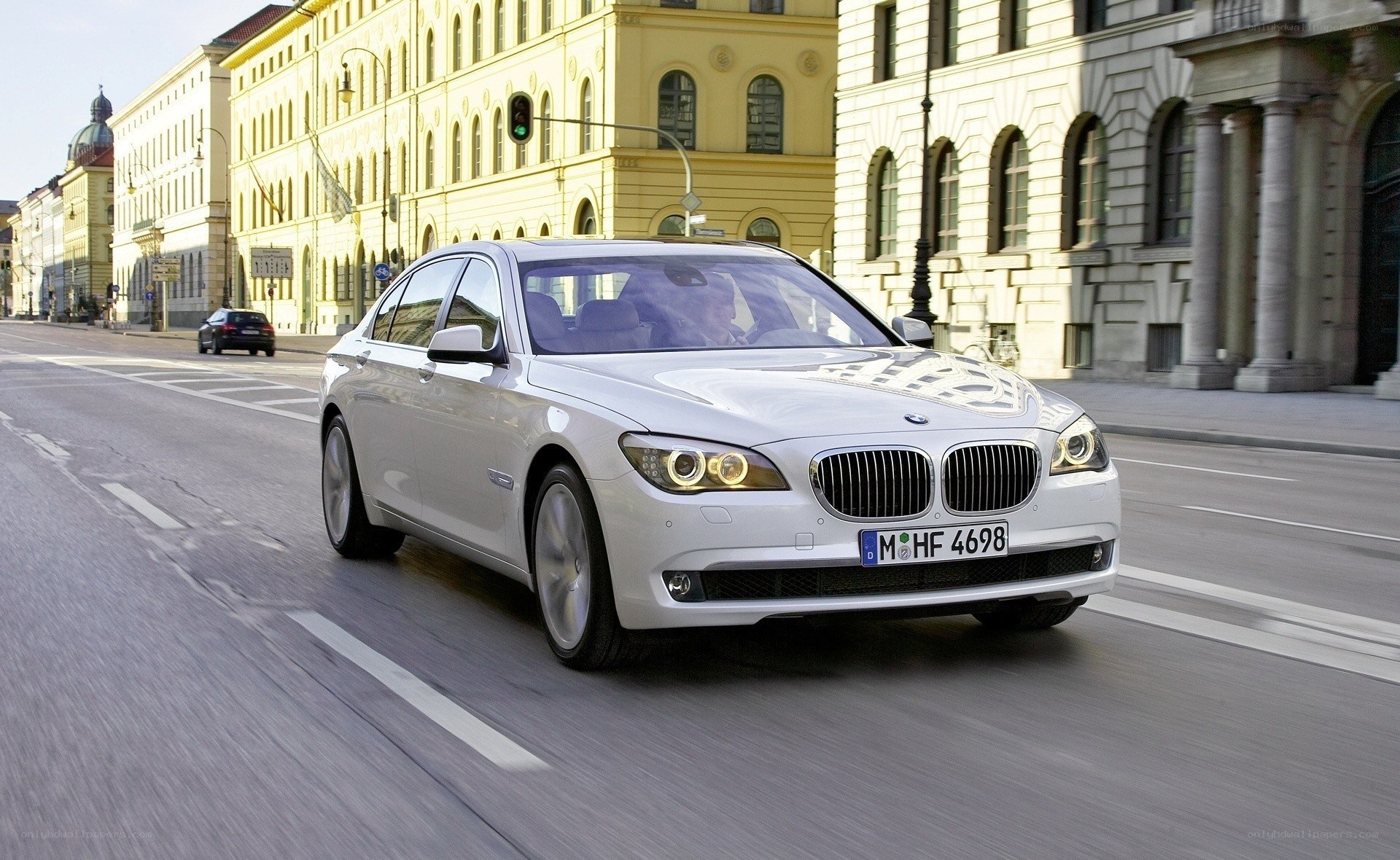 White BMW driving in city