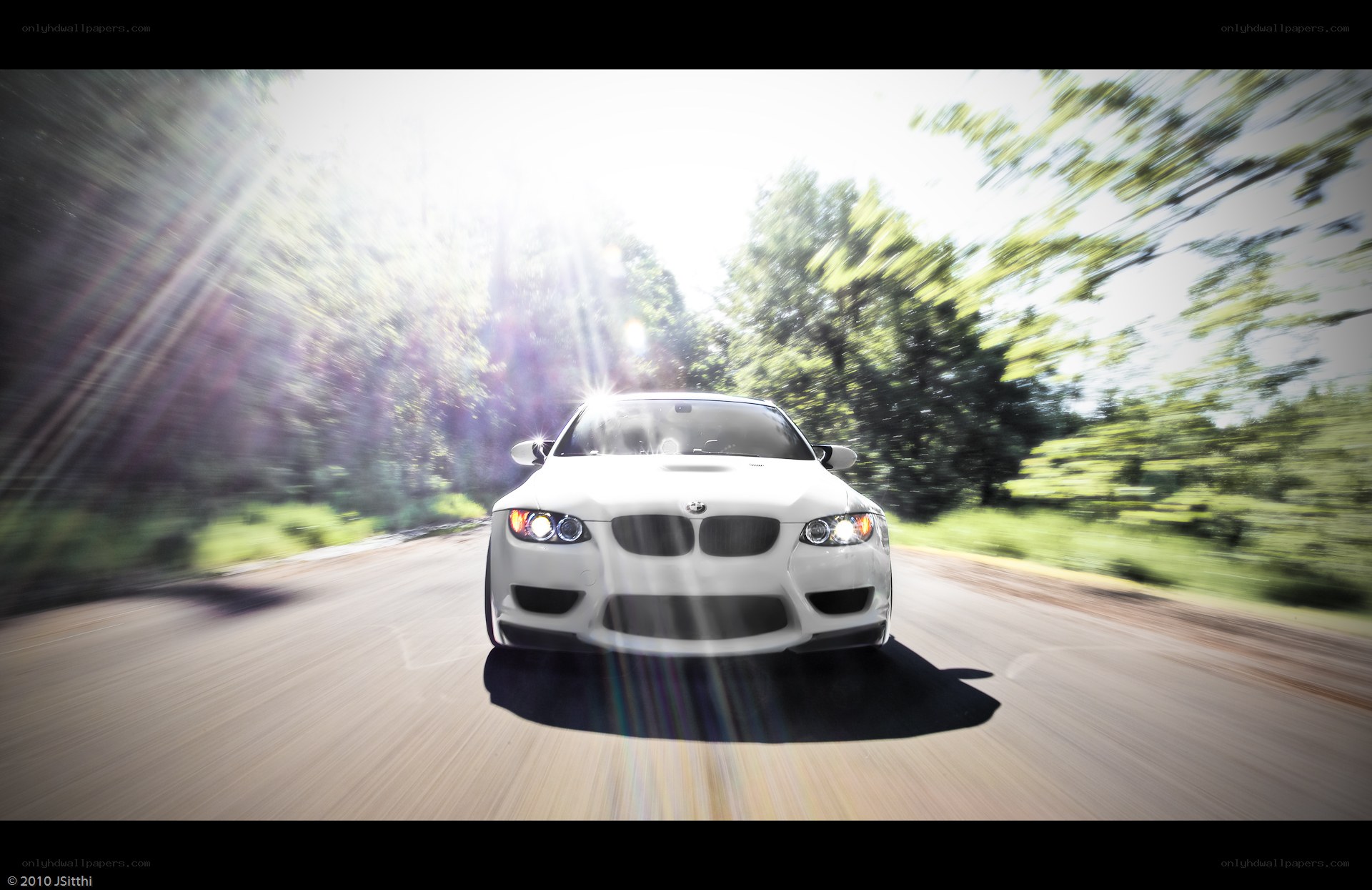 White BMW driving on a road