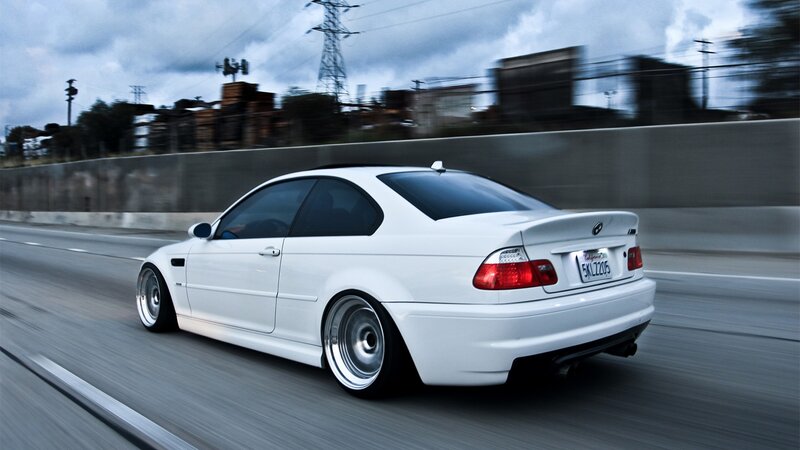 white bmw driving on highway