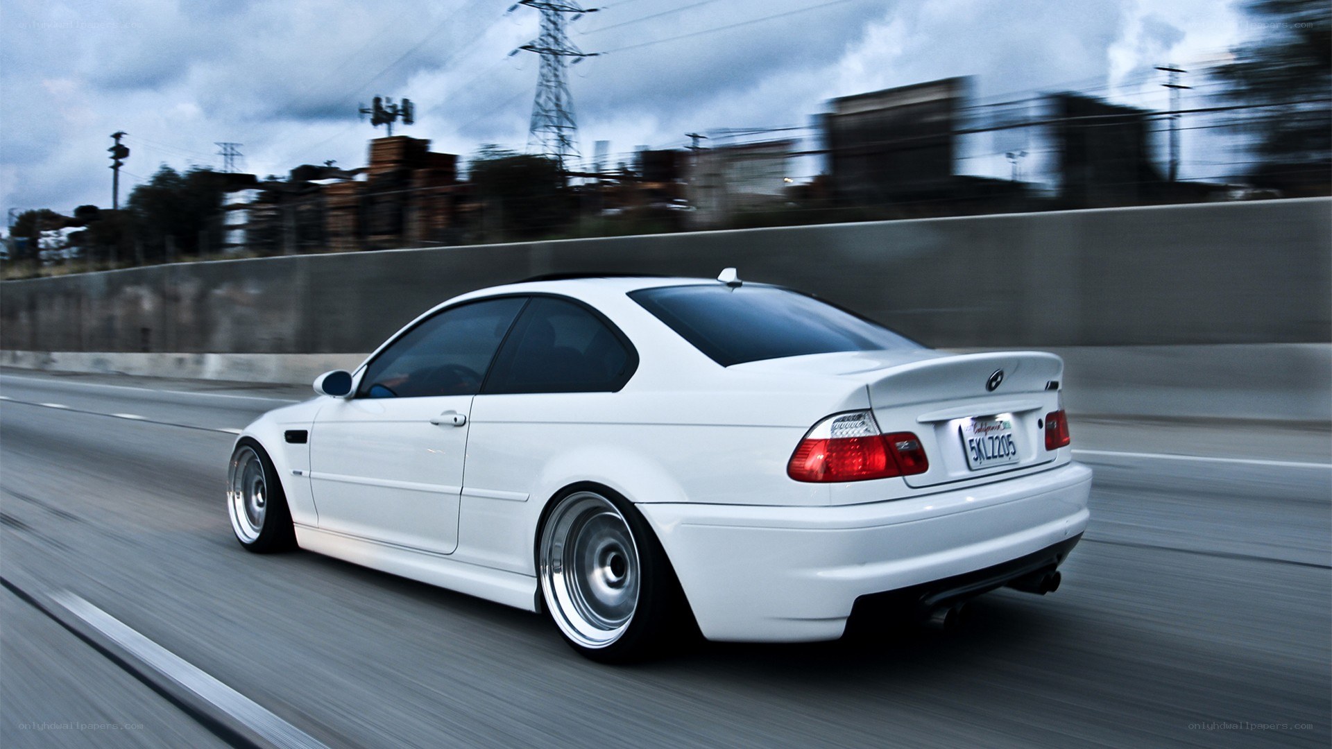 white bmw driving on highway