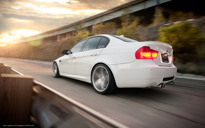 white bmw driving on road
