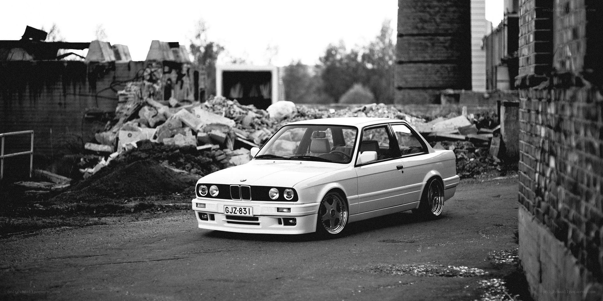 White BMW in a derelict area
