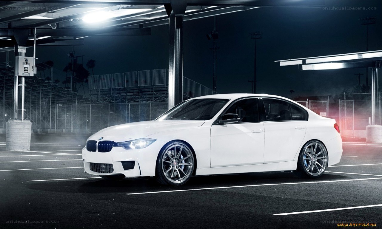 white bmw in a parking garage