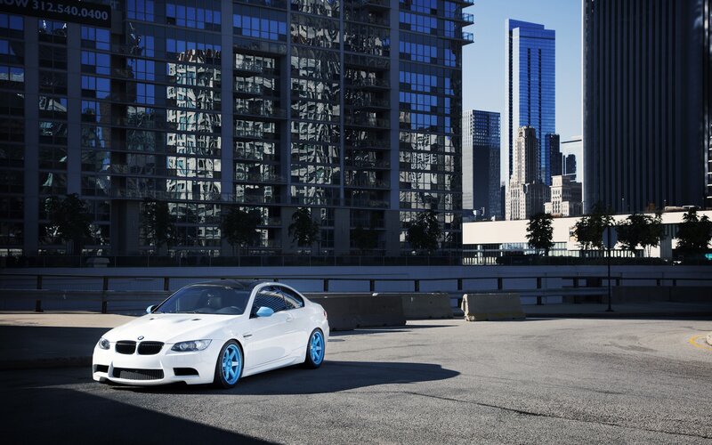 white bmw in city parking