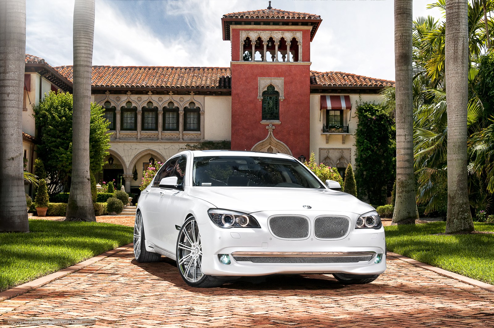 White BMW in front of mansion