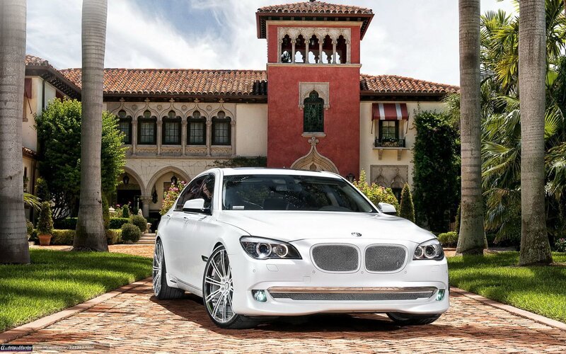 White BMW in front of mansion