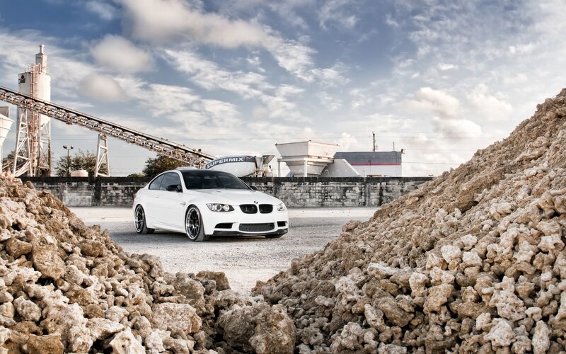 White BMW in industrial yard