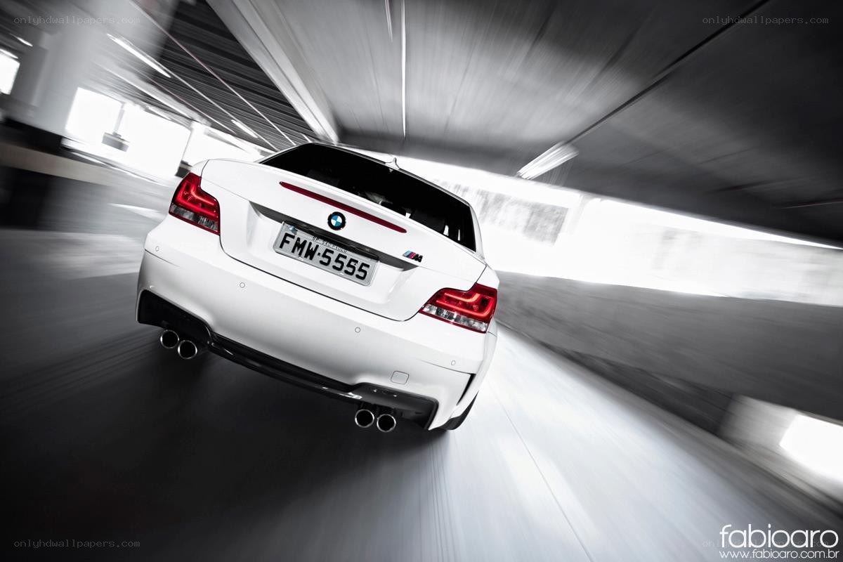 White BMW M1 driving fast