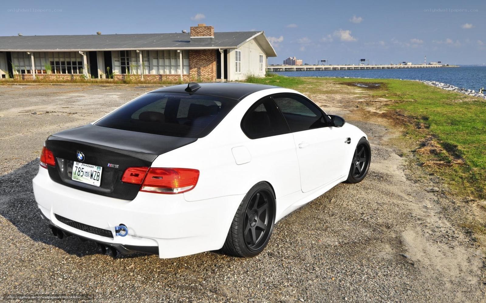 white bmw m3 by the water